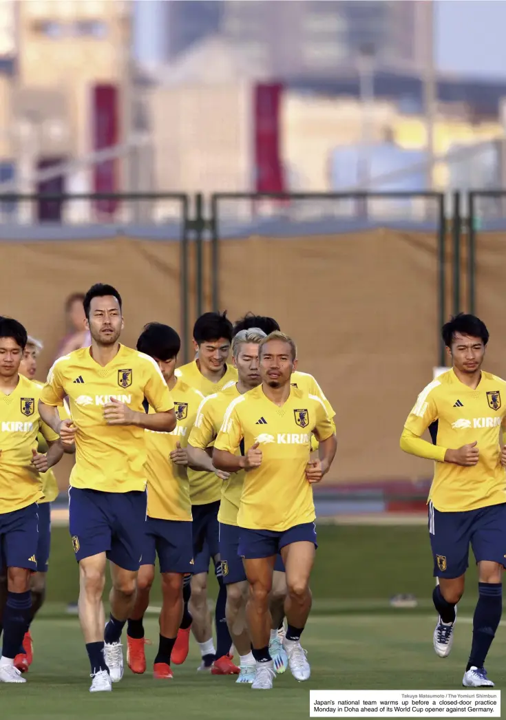  ?? Takuya Matsumoto / The Yomiuri Shimbun ?? Japan’s national team warms up before a closed-door practice Monday in Doha ahead of its World Cup opener against Germany.