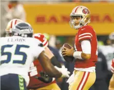  ?? Lachlan Cunningham / Getty Images ?? Jimmy Garoppolo was in the game for three snaps against the Seahawks and came out with a quarterbac­k rating of 143.7.