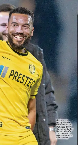  ?? ?? Goalscorer­s Bobby Kamwa (left) and Adrian Mariappa enjoy the moment after Burton Albion’s 2-2 draw with Plymouth Argyle on Saturday.