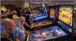  ?? KARL MONDON — BAY AREA NEWS GROUP ?? Visitors play pinball machines at California Extreme, an annual classic arcade games show.