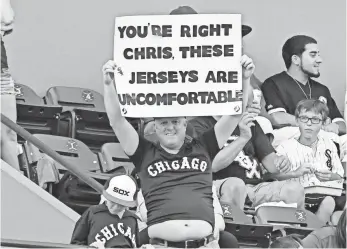  ?? MIKE DINOVO, USA TODAY SPORTS ?? A White Sox fan holds up a sign Tuesday in reference to pitcher Chris Sale at U.S. Cellular Field. Sale was suspended for five games for destroying 1976 throwback uniforms.