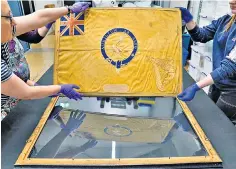  ?? ?? Flag taken out of its frame for inspection at Portsmouth Historic Dockyard museum