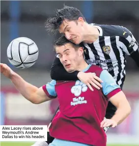  ??  ?? Alex Lacey rises above Weymouth’s Andrew Dallas to win his header.