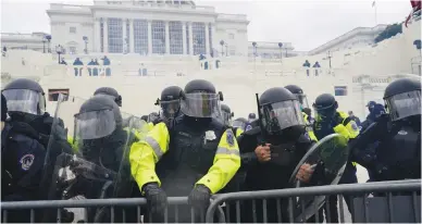  ?? Los Angeles Times/tns ?? Police try to hold back protesters who gather to storm the Capitol and halt a joint session of Congress on Jan. 6 in Washington, D.C.