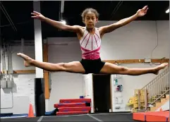  ?? HERALD PHOTO BY JUSTIN SEWARD ?? Amalia Yavitu does a switch split to strattle move at the West Winds Gymnastics Club on Friday.