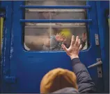  ?? (AP/Emilio Morenatti) ?? Stanislav says goodbye to his 2-year-old son, David, and wife, Anna, on March 3 after they boarded a train that would take them to Lviv, from the station in Kyiv, Ukraine. Stanislav stayed to fight as his family sought refuge in a neighborin­g country.