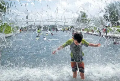  ?? JOSHUA ROBERTS/ REUTERS ?? Children play in a fountain during a heat wave in Washington, US, on Wednesday.