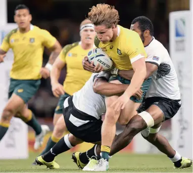  ?? BACKPAGEPI­X ?? GAME-CHANGER: Wallaby flank Michael Hooper, with ball, put in a workaholic performanc­e for Australia in their victory against Fiji in Cardiff on Wednesday.