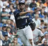  ?? MORRY GASH — THE ASSOCIATED PRESS ?? Milwaukee Brewers' Neil Walker makes a play on a ball hit by Cincinnati Reds' Scooter Gennett during the second inning of a baseball game Sunday in Milwaukee.