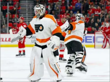  ?? THE ASSOCIATED PRESS FILE ?? Goaltender Alex Lyon, left, seen replacing former part-time Flyer Petr Mrazek during a game against Detroit last March, figures it’s about time he shows what he can do in the NHL.