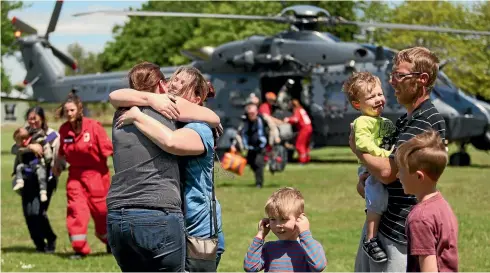  ?? PHOTO: JOSEPH JOHNSON/FAIRFAX NZ ?? A Kaikoura family, arriving at Woodend School in Christchur­ch after being evacuated by the Defence Force, receive an emotional welcome.