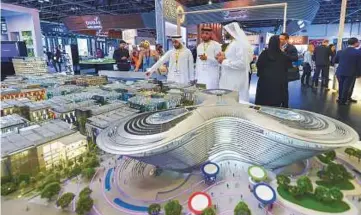  ?? Ahmed Ramzan/ Gulf News ?? Visitors viewing the Dubai Expo 2020 stand on the first day of Cityscape Global 2017 at the Dubai World Trade Centre and Exhibition Halls, yesterday.