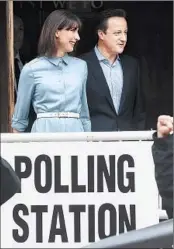  ?? ANDY RAIN/EPA ?? British Prime Minister David Cameron leaves a polling place Thursday with his wife, Samantha, in Spelsbury.