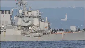  ?? AP/EUGENE HOSHIKO ?? The USS Fitzgerald limps to port Saturday. A statement from the U.S. 7th Fleet said water had to be pumped out of flooded areas of the ship after it was crushed on the starboard side.