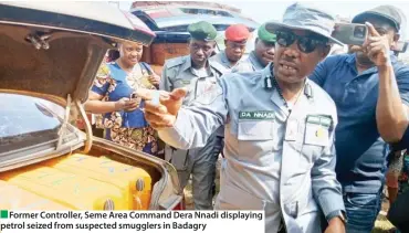  ?? ?? Former Controller, Seme Area Command Dera Nnadi displaying petrol seized from suspected smugglers in Badagry ??????????