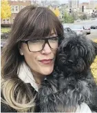  ?? GERALYNN CADA VIA THE ASSOCIATED PRESS ?? Geralynn Cada, posing with her dog, Buddy, in Kansas City, Mo., says teach your dog or cat a few tricks now, and your golden years will be better for it.