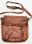  ??  ?? Right: This vintage leather satchel goes everywhere with the actor