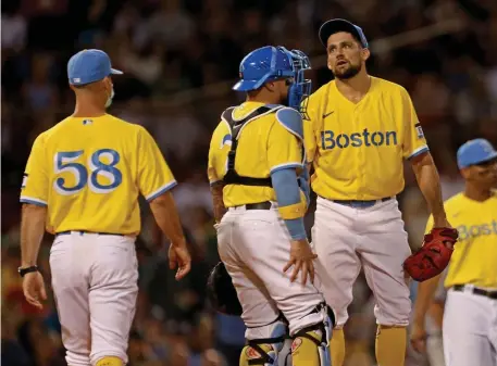  ?? Stuart caHill pHotoS / Herald Staff ?? TROUBLE FROM THE START: Red Sox starting pitcher Nathan Eovaldi, right, takes a breath after a rough start during the first inning against the Yankees on Friday night at Fenway Park. Below, Christian Vazquez jumps out of the way of an inside pitch during the second inning.