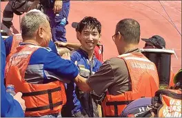  ?? U.S. COAST GUARD VIA AP ?? A crew member of the capsized cargo ship Golden Ray smiles as he is helped off the ship Monday off St. Simons Island, Ga. The ship overturned and caught fire Sunday.