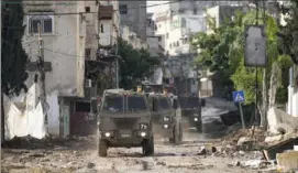  ?? Majdi Mohammed/Associated Press ?? Israeli military vehicles in the West Bank in November.