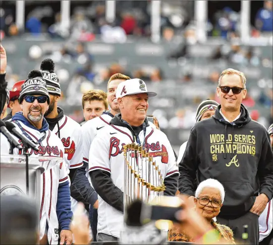  ?? DANIEL VARNADO FOR THE AJC 2021 ?? Braves manager Brian Snitker (center) enjoys a ceremony after the parade at Truist Park on Nov. 5 celebratin­g Atlanta’s World Series title. This season, they’ll try to do what no MLB team has done in the past 21 years: win back-to-back World Series.