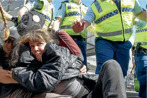  ?? KEVIN STENT/STUFF ?? A woman tries to avoid being taken away by police at a protest outside Westpac Stadium in October 2017.