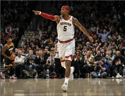  ?? AARON ONTIVEROZ — THE DENVER POST ?? Kentavious Caldwell-pope of the Denver Nuggets celebrates hitting a three pointer against Duane Washington Jr. of the Phoenix Suns during the first quarter at Ball Arena in Denver on Jan. 11.