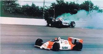  ?? RON WEAVER/ASSOCIATED PRESS FILE ?? In 1989, Emerson Fittipaldi, bottom, takes the lead after Albuquerqu­e’s Al Unser Jr. hits the wall with less than two laps remaining in the Indy 500.