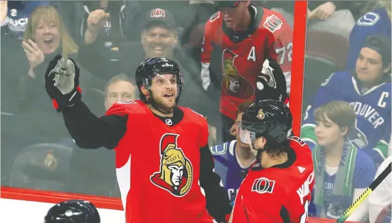  ?? FRED CHARTRaND/ THE CANADIAN PRESS ?? Senators right wing Bobby Ryan celebrates his goal against the Vancouver Canucks with defenceman Ron Hainsey in Ottawa on Thursday.