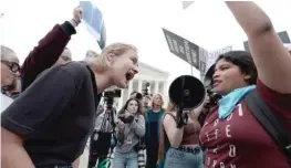  ?? ANNA MONEYMAKER/GETTY IMAGES ?? Pro-choice and anti-abortion activists confront each other Tuesday in front of the U.S. Supreme Court in Washington, D.C.