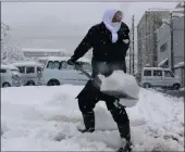  ?? PICTURE: REUTERS ?? A man clears snow at a parking lot in Gosen, Niigata Prefecture, Japan.