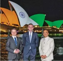  ?? ?? NSW Premier Dominic Perrottet and Minister for Multicultu­ralism Mark Coure welcomed the lighting up of the iconic Sydney landmark in orange, white and green to commemorat­e India’s milestone anniversar­y.