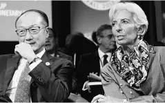  ??  ?? World Bank President Jim Yong Kim ( left) and Internatio­nal Monetary Fund (IMF) Managing Director Christine Lagarde attend a Developmen­t Committee plenary during the IMF/World Bank annual meetings in Washington, US