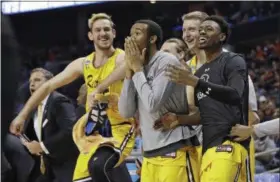  ?? GERRY BROOME — THE ASSOCIATED PRESS ?? UMBC players celebrate a teammate’s basket against Virginia during the second half of a first-round game in the NCAA tournament in Charlotte, N.C., on March 16.