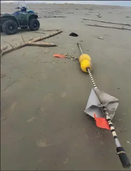  ?? Photo by Robert Tokeianna Jr ?? TAG— A Russian buoy marker and fishing tag were found near Wales on September 21. Aside from the marker, there were also plastic milk drink bottles, water bottles, air freshener cans and toilet bowl cleaner bottles found.