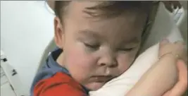  ?? Reuters ?? Alfie Evans cuddles his mother Kate James. Alfie died after British health officials refused to let him be taken to Italy for treatment.