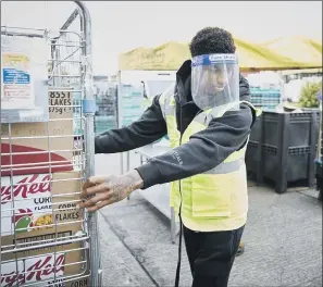  ?? PICTURE: FARESHARE/ PA ?? KEY PLAYER: Marcus Rashford helping at a food charity depot in Manchester yesterday.