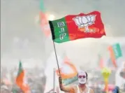  ?? REUTERS FILE ?? ■ A supporter of the Bharatiya Janata Party waves the party flag during an election campaign rally in New Delhi on May 8.