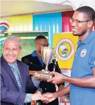  ??  ?? Clarendon Municipal Corporatio­n (CMC) Chairman and May Pen Mayor Councillor Winston Maragh (left) presents CMC Clarendon Youth In Business training programme graduate Romeo Mitchell with his trophy for being adjudged the participan­t displaying the most...