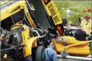  ?? BOB KARP — THE DAILY RECORD (VIA AP) ?? Emergency personnel examine the school bus after Thursday’s crash on Interstate 80 in Mount Olive, N.J.