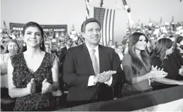  ?? DOUG MILLS/THE NEW YORK TIMES 2020 ?? Florida Gov. Ron DeSantis, seen with his wife Casey, left, and Kimberly Guilfoyle, may be emerging as the face of the post-Trump right.