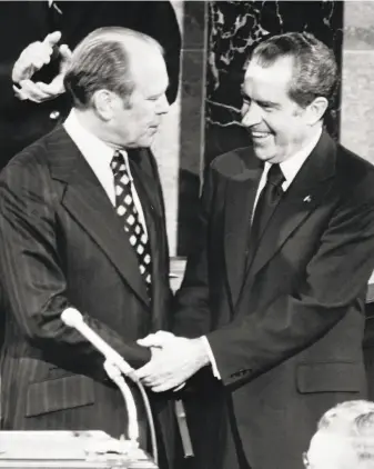  ?? AFP / Getty Images 1973 ?? Gerald Ford, shown with Richard Nixon in 1973, made sure the president wouldn’t face charges by pardoning him soon after Nixon resigned and Ford became president.