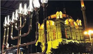  ?? Courtesy: @HDNER on Twitter ?? First time in Turkey The traditiona­l lighting of Hanukkah candles in Istanbul’s upscale Ortakoy district. Turkish Jews publicly celebrated the annual Hanukkah holiday for the first time in Turkey’s modern history.