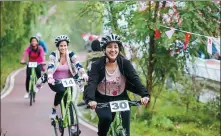  ?? PROVIDED TO CHINA DAILY ?? From left: Bicycle fans participat­e in a fitness festival in the Wenjiang Greenway in Chengdu.