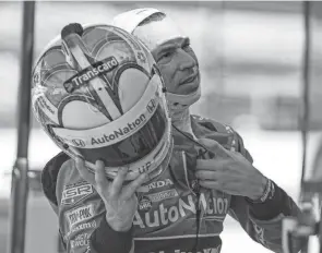  ?? GRACE HOLLARS/INDIANAPOL­IS STAR ?? Meyer Shank Racing driver Helio Castroneve­s takes off his helmet after the first practice of the GMR Grand Prix on May 13 at Indianapol­is Motor Speedway.