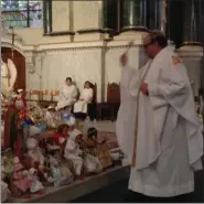  ?? SUBMITTED PHOTO ?? Rev. Gus Puleo, pastor of St. Patrick’s Church, blesses the baby Jesus statues.