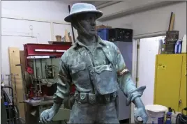  ??  ?? The Associated Press The World War I Highbridge Doughboy statue, which was was erected in the Bronx in 1923, under repairs at the NYC Parks monument repair facility in the Brooklyn borough of New York. World War I monuments nationwide have been...