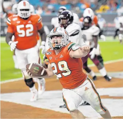  ?? MICHAEL LAUGHLIN/SUN SENTINEL ?? Miami running back Jimmy Murphy celebrates after scoring a touchdown against Bethune-Cookman during the second half Saturday.