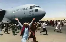  ?? Associated Press ?? Afghans desperate to escape the Taliban capture of their country last August chase a U.S. transport plane in Kabul.