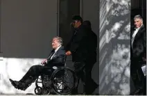  ?? Jerry Lara / Staff photograph­er ?? B.J. “Red” McCombs is escorted out of Alamo Heights United Methodist Church after memorial services for his wife, Charline, on Tuesday.